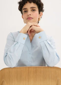 Blusa elástica de popelín con cuello chimenea y ligera transparencia