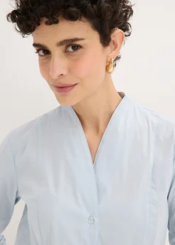 Blusa elástica de popelín con cuello chimenea y ligera transparencia