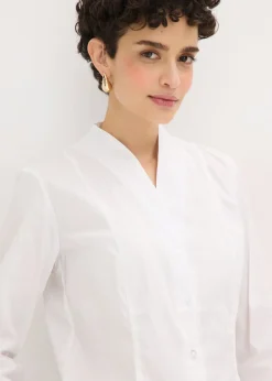 Blusa elástica de popelín con cuello chimenea y ligera transparencia