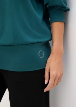 Camiseta deportiva con corte holgado, mangas ¾ y material de secado rápido