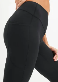 Cómodos leggings deportivos con bolsillo para móvil, corte acampanado y material de secado rápido
