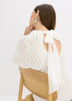 Vestido corto de punto con lazo de satén y ligeras transparencias